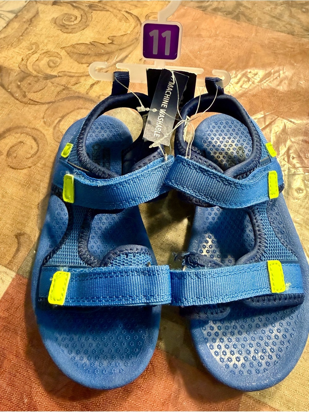Blue OshKosh B'gosh sandals with neon green accents.